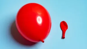one-inflated-and-one-deflated-red-balloons-side-by-side